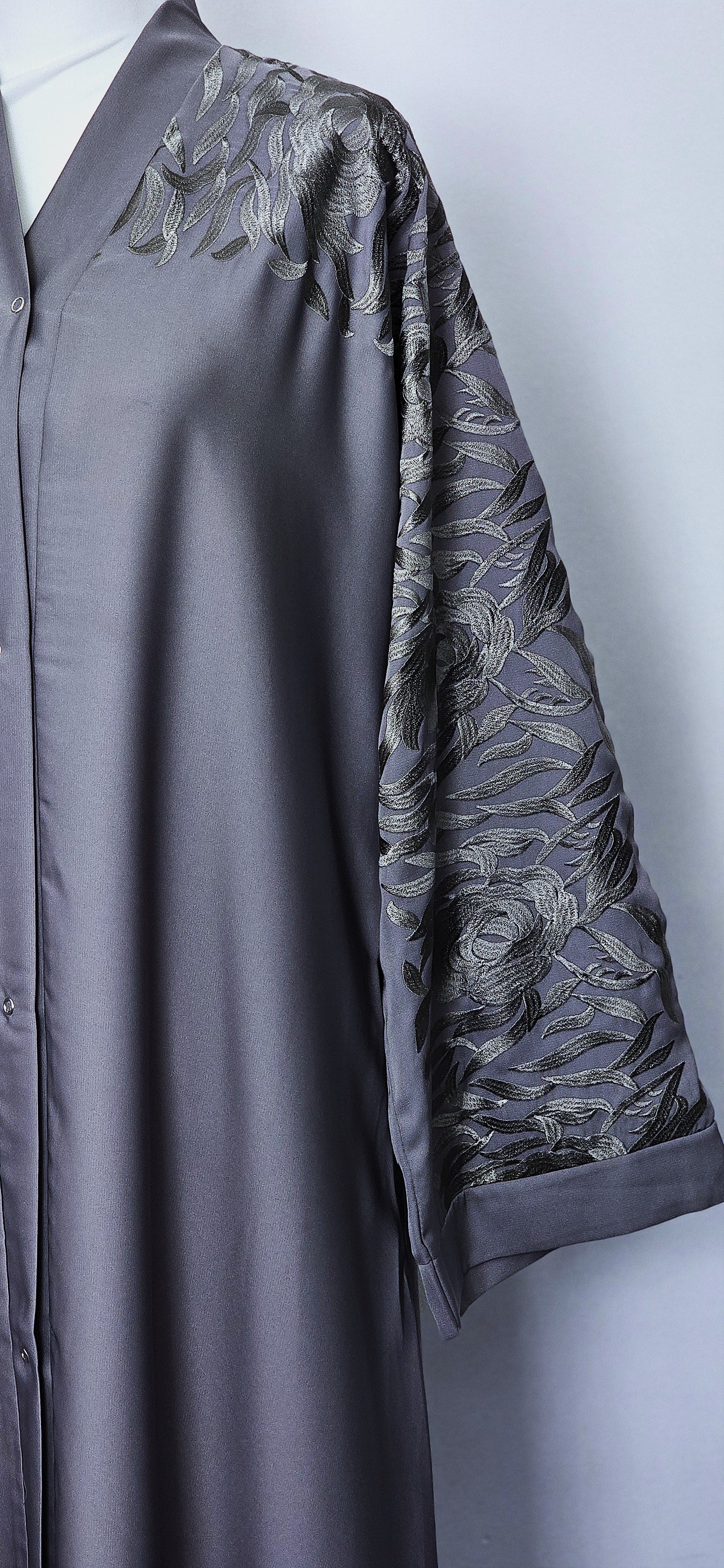 Grey abaya with embroidered sleeves. 